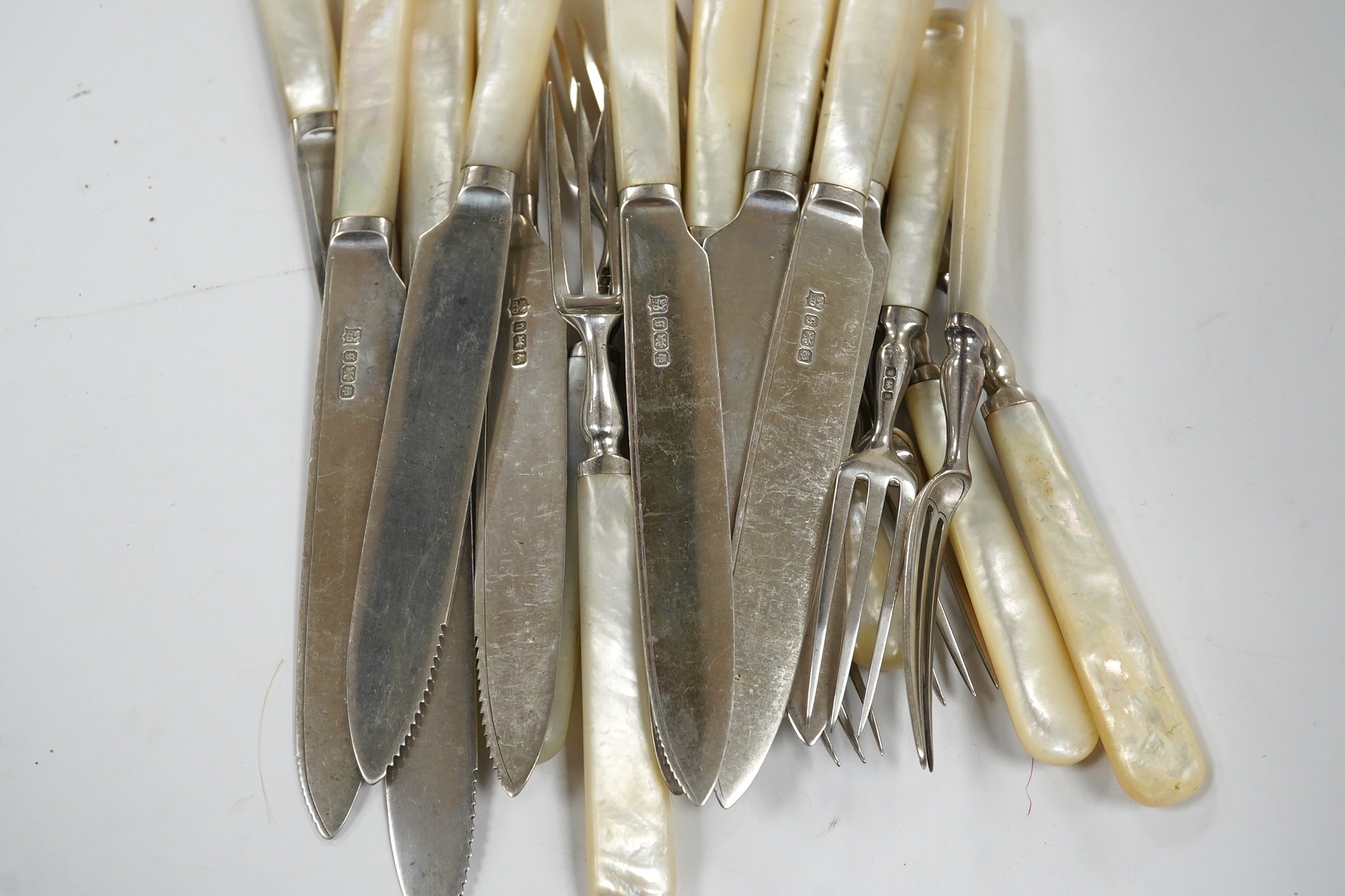 Ten George V mother of pearl handled silver dessert eaters and eleven matching forks, Cooper Brothers & Sons, Sheffield, 1910/13. Condition - fair